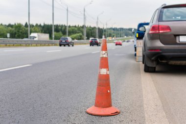 Yoldaki trafik konilerinin dikkatine. Seçici odaklanma. Çekici yolda bozuk bir arabayı çekiyor.