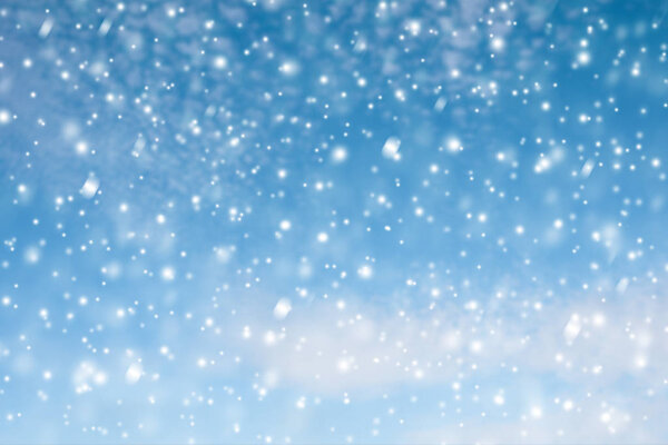 Winter blue sky with falling snow, snowflake. Holiday Winter background. Merry Christmas and Happy New Year.  