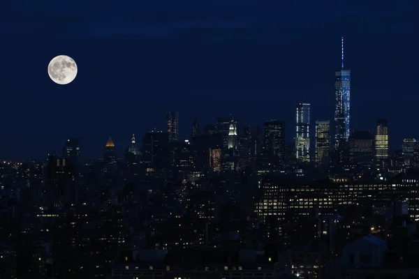 Aerial and panorama view of skyscrapers of New York City, Manhattan.  Top view of night midtown of Manhattan with stars and moon. 