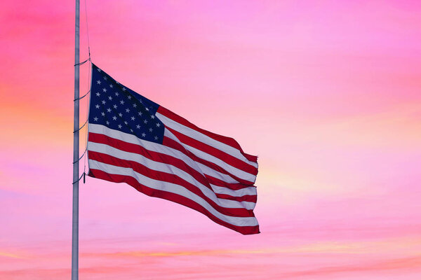 American flag on the sunset sky background