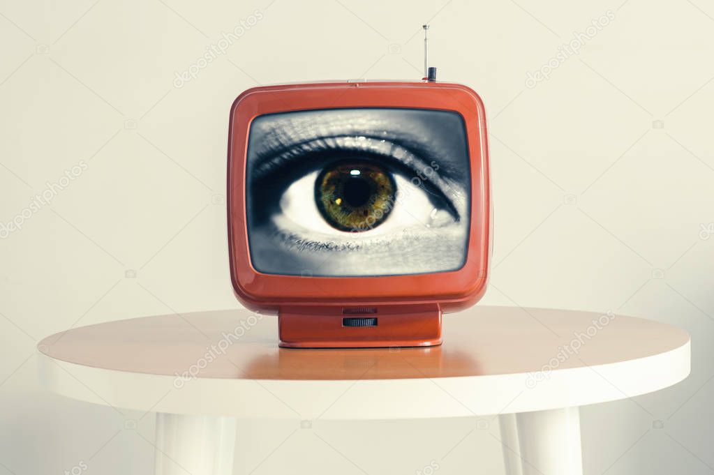 Female eye in an old retro TV screen. Creative concept. looking to the future