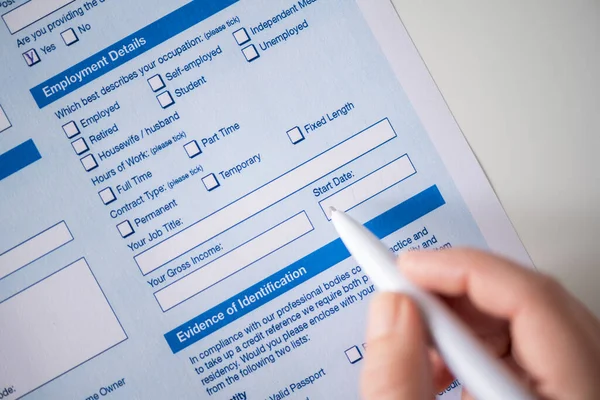 Woman filling employment contract, tick start data of work in count employment detail. Close up. Selective focus.