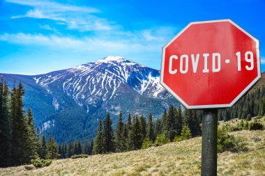 Mountains range with COVID-19 sign. Warning about global pandemic. Coronavirus disease. COVID-19 alert sign clipart
