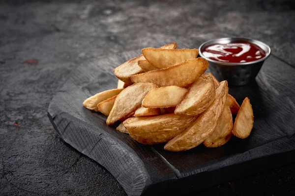 Home made french fries with ketchup on a dark background. — Stock Photo, Image