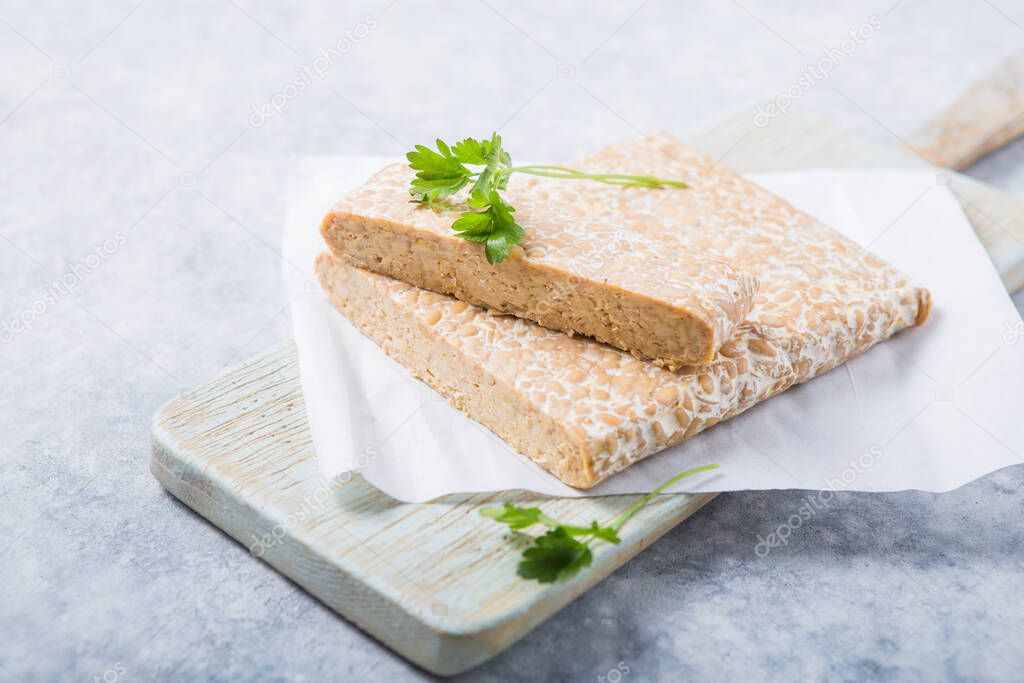 Slice of tempeh  or tempe made of fermentation process that binds soybeans, is traditional food from Indonesia and Malaysia