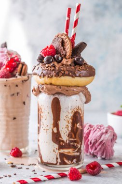 Çikolata düşkünü dondurmalı milkshake, donut ve şekerli. Deli saçması yemek trendi. Boşluğu kopyala
