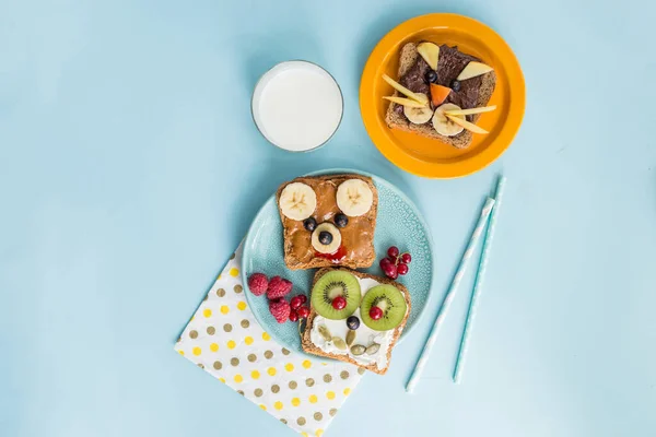 Funny breakfast toast for kids shaped as cute cat, dog, bear, fish. Food art sandwich for child. Isolated. Animal faces toasts with spreads, fruits