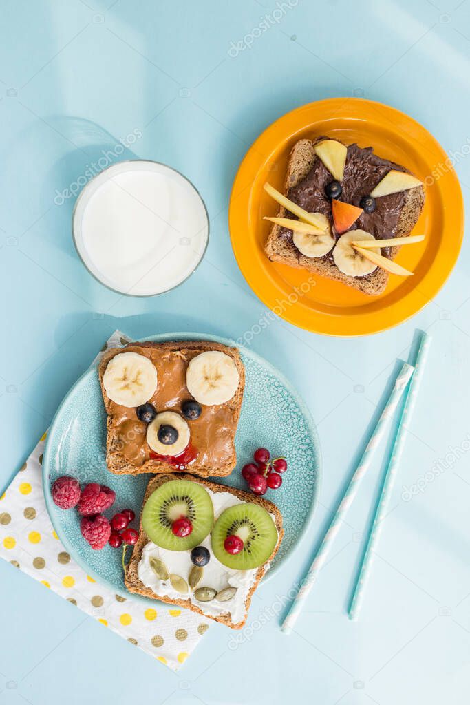 Funny breakfast toast for kids shaped as cute cat, dog, bear, fish. Food art sandwich for child. Isolated. Animal faces toasts with spreads, fruits