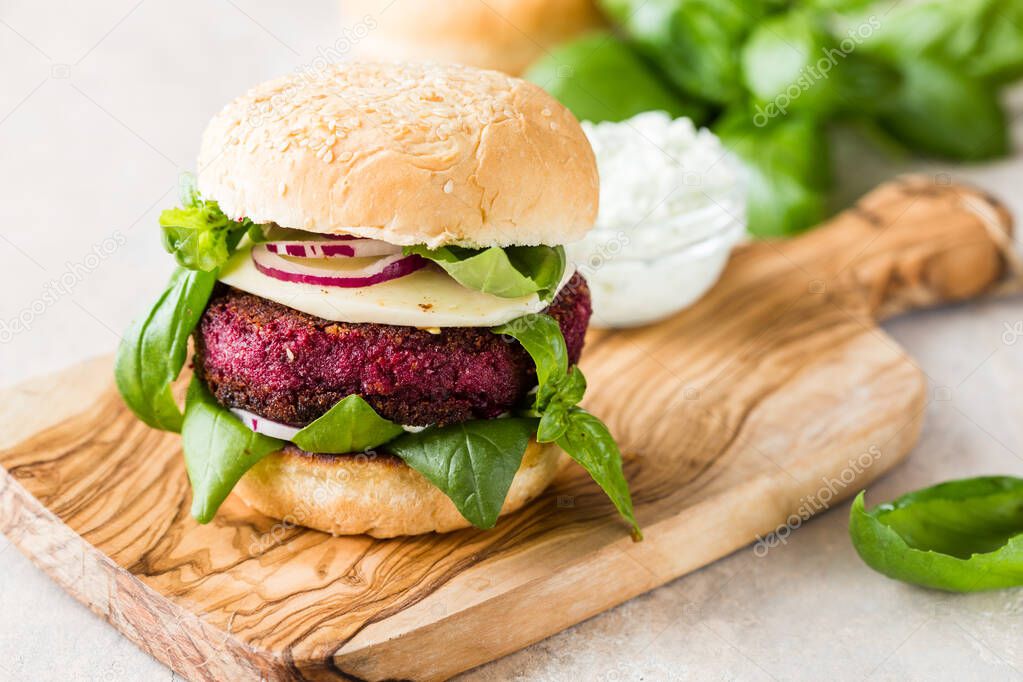 Veggie beet  burgers with vegetables and  greek sauce. Healthy food concept.