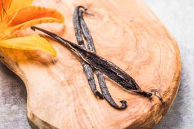 Dried vanilla pods on wooden table. Close-up. clipart
