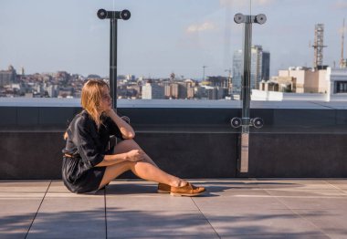 Yalnızlık içinde bir evin çatısındaki bir kız meditasyon yapıyor ya da hayattan zevk alıyor ya da dijital bir detoks yaşıyor. Ruhu aramak..