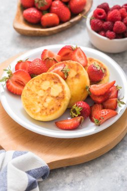 Tatlı süzme peynirli gözleme tabakta çilek vardı. Rus şurubu, ricotta böreği ya da kremalı börek..