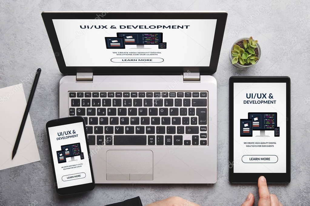 UI/UX design and development concept on laptop, tablet and smartphone screen