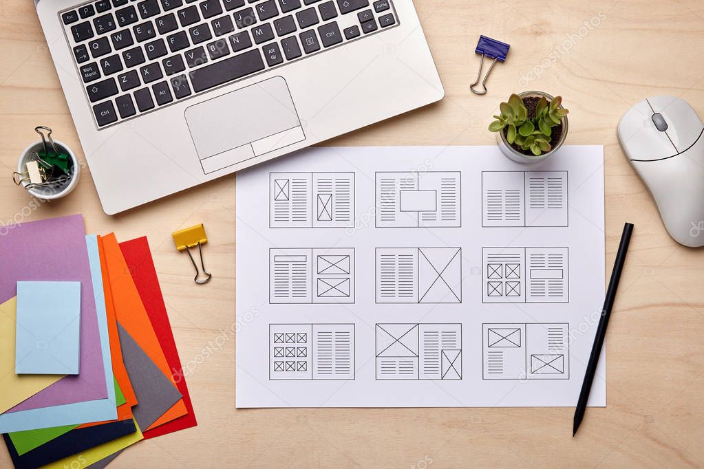 Editorial designer desk with publication layout 