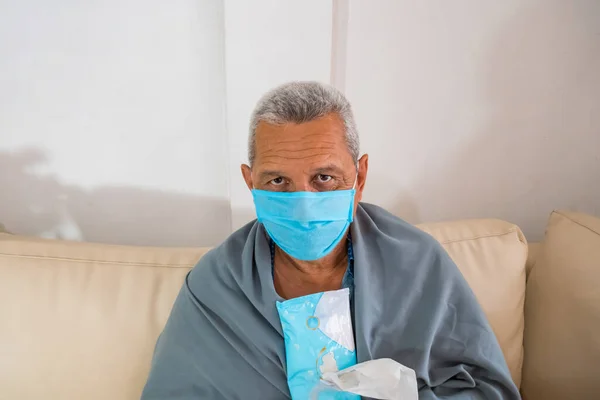 Sick Hispanic man with medical mask