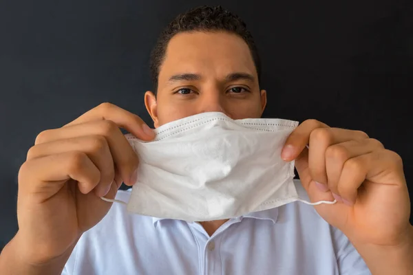 Man with mask in a close-up portrait of a medical mask. Medical attention. Symptoms of Covid-19 coronavirus