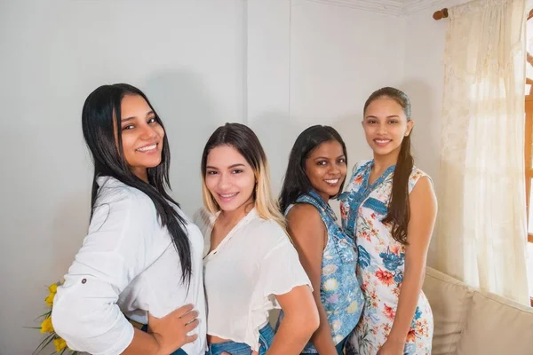 Group of four young and diverse girls posing, urban fashion style