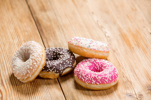 Donuts on wooden background 