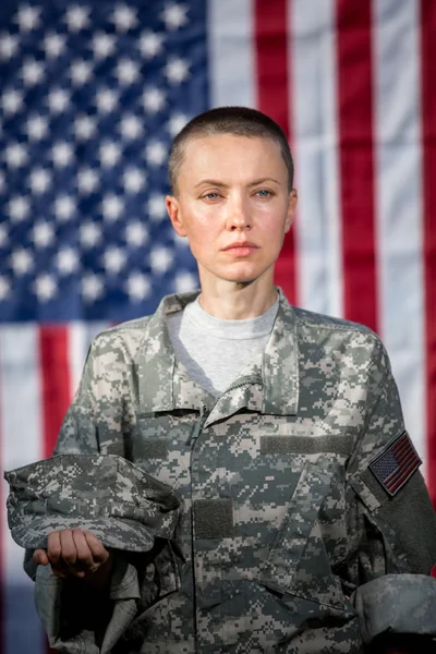 アメリカ国旗の前で女性アメリカ陸軍兵士 — ストック写真