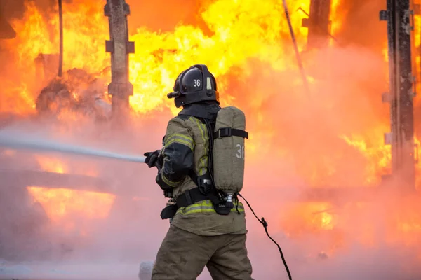 Firefighter Extinguishes Truck Royalty Free Stock Photos