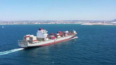 Mediterranean Sea - June 14, 2020: Large loaded container Ship cruising slowly at Sea, Aerial view.