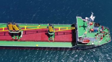 Mediterranean Sea - June 14, 2020: Large Cargo Ship with four Yellow cranes at sea, Drone footage.