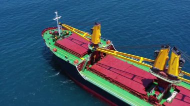 Mediterranean Sea - June 14, 2020: Large Cargo Ship with four Yellow cranes at sea, Drone footage.