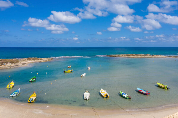 Small Fishing Boats anchored in a shallow lagoon, Aerial image.