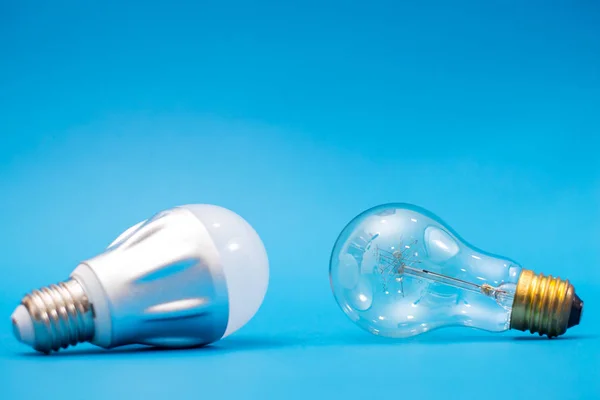 LED bulb and simple light bulb.Blue background