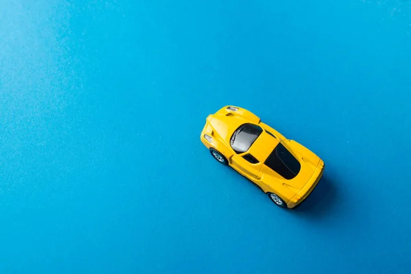 stock image top view of toy car on blue background, minimalistic concept