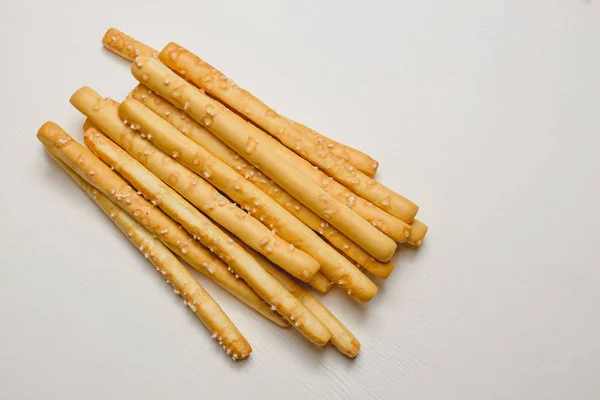 Traditional Italian snack, bread - grissini. On a dark stone table, top view, copy space