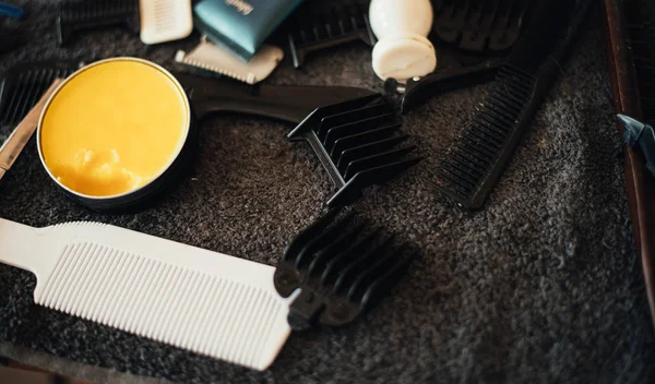 close up view of wax and hair brushes barbershop