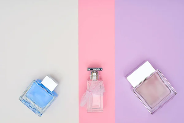 Perfume bottles on pastel background. Minimal style.