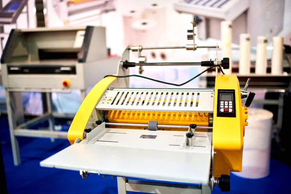 Plastic laminating machine on background,close up