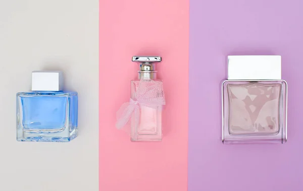 Perfume bottles on pastel background. Minimal style.