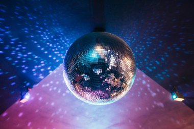 shiny disco ball hanging in night club, night party background clipart