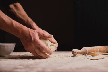 kısmi görmek erkek el ahşap masa üzerinde hamur yoğurma