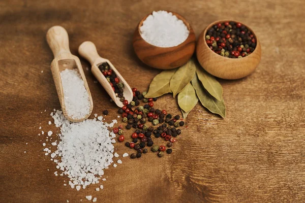 food composition with salt and pepper on wooden table