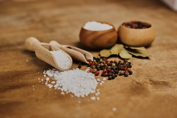 food composition with salt and pepper on wooden table