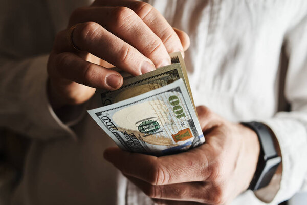 cropped shot of businessman with american dollars banknontes 