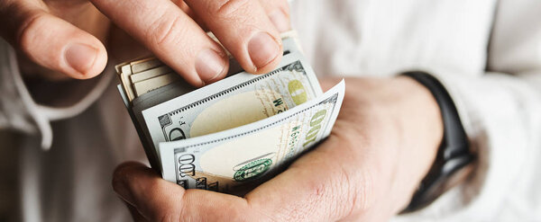 cropped shot of businessman with american dollars banknontes 