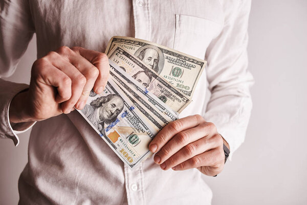 cropped shot of businessman with american dollars banknontes 