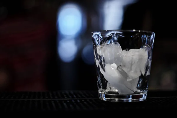 empty glass with ice cubes at bar
