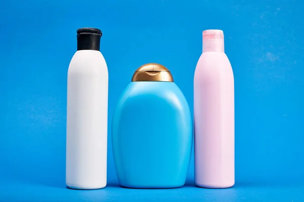 Studio shot of bottles with hair shampoo and gel showers