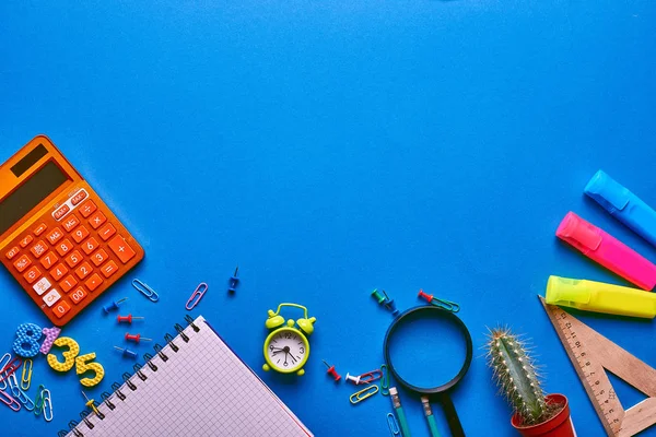 Back to school concept on a blue wooden background