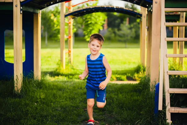 boy is having fun on the playground in the park