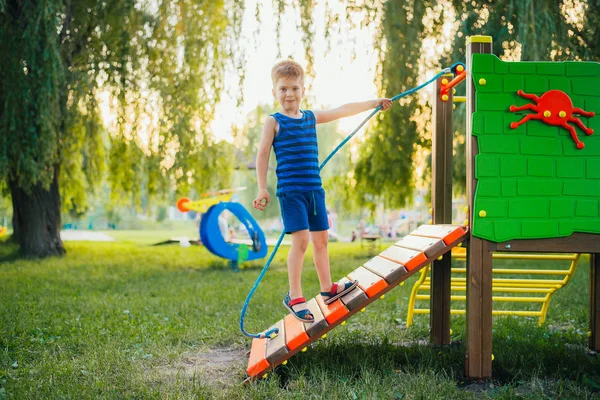 boy is having fun on the playground in the park