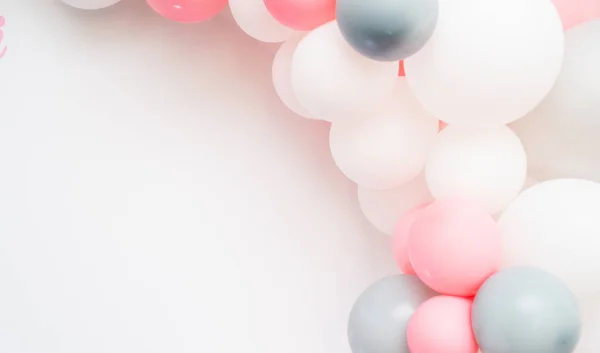 Balloons on pastel pink background. Frame made of white and pink balloons. Birthday, valentines day, holiday concept. Flat lay, top view, copy space