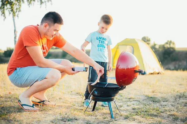 A man is cooking barbecue food at nature