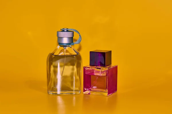 Perfume bottles on yellow background. Minimal style